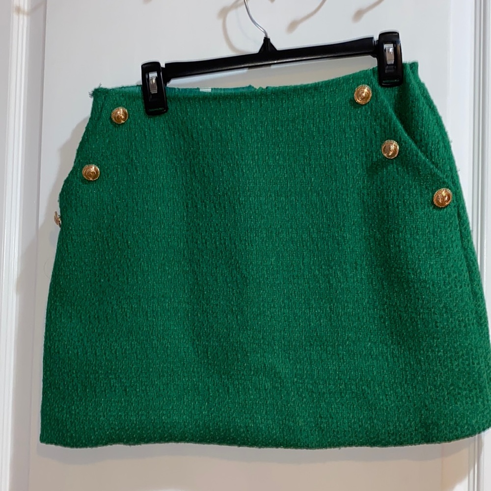 Green tweed mini skirt with gold buttons and pockets